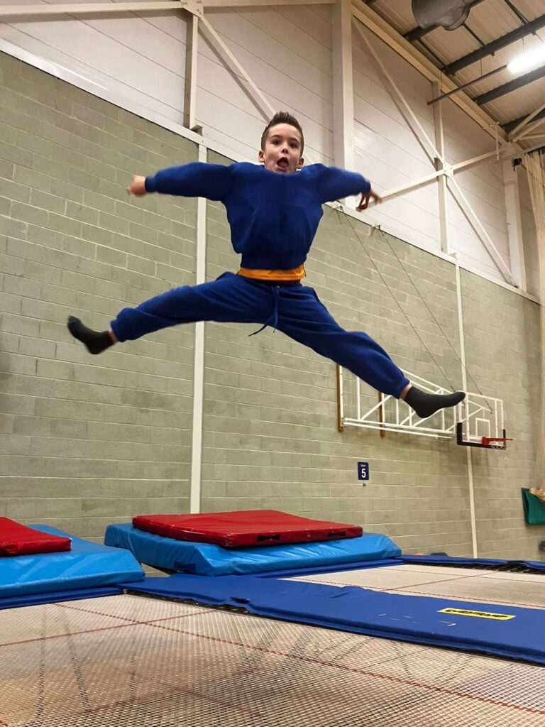 Boy jumping on trampoline